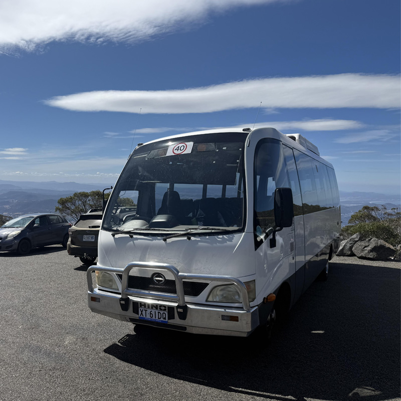 White minibus with a bull bar in a mountain lookout car park